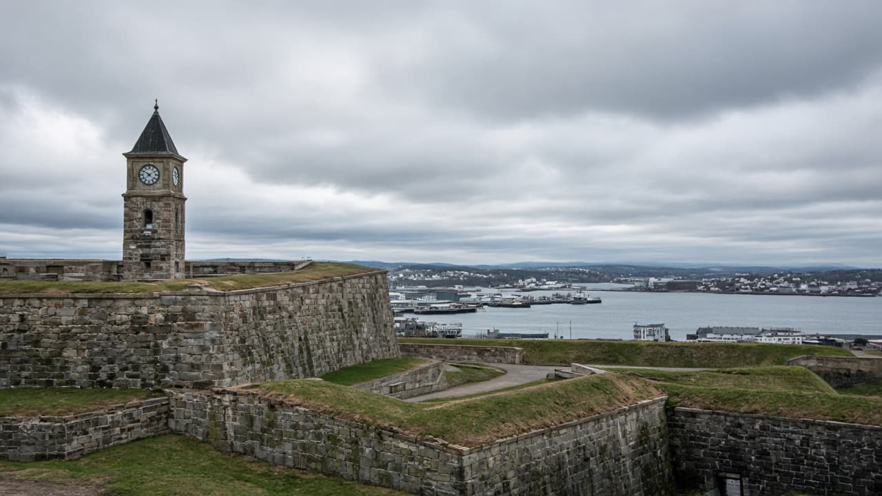 The stone ramparts and clock tower of Halifax Citadel, with the harbour beyond